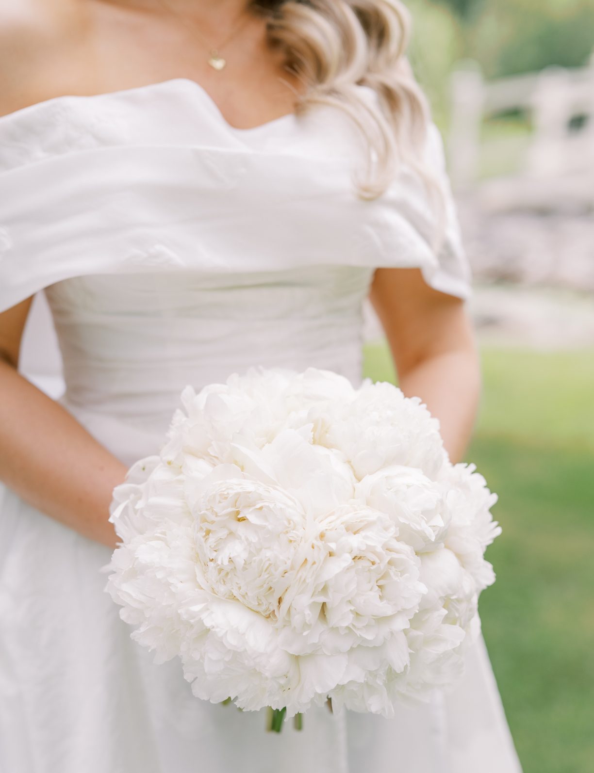 An all white bridal bouquet made up of all peonies.