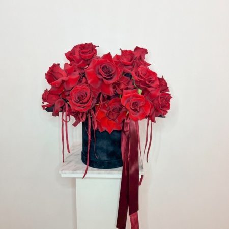 A beautiful black velvet hat box designed with reflexed red roses