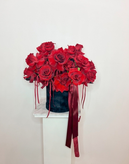 A beautiful black velvet hat box designed with reflexed red roses