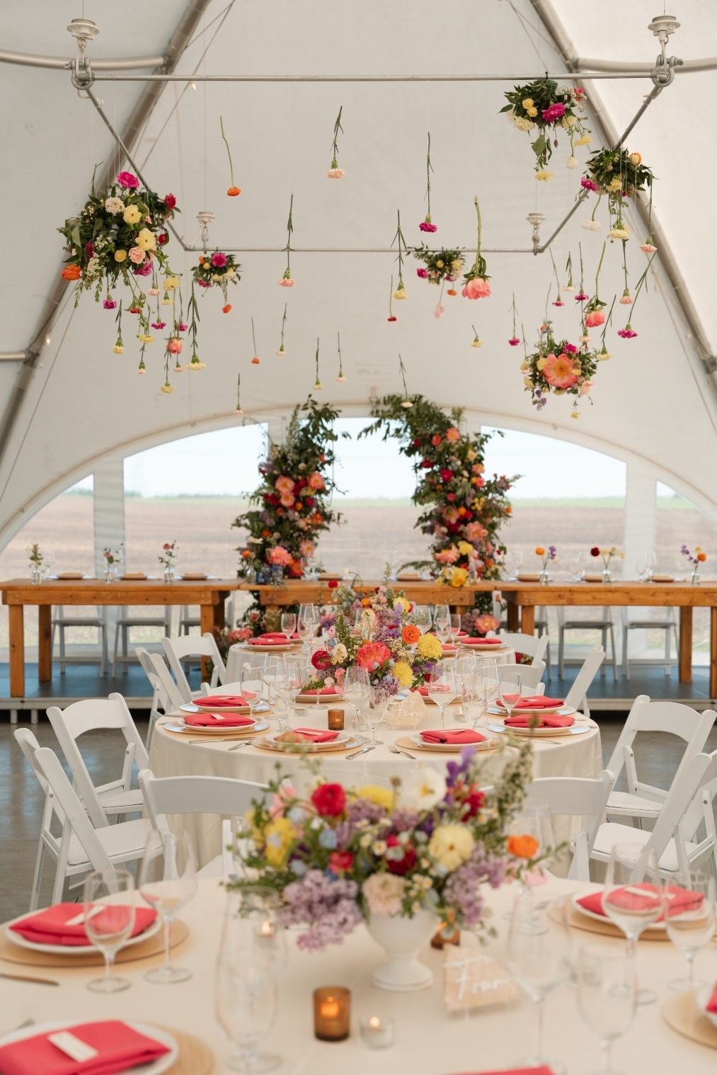 Colourful Garden Inspired Reception A stunning tented reception set up at River's Edge, full of colour and garden inspired blooms.