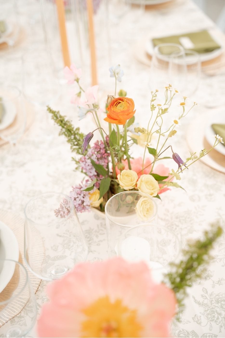 Garden Blooms Ikebana An ikebana inspired centrepiece featuring lilac, chamomile, ranunculus, peony and spray roses.