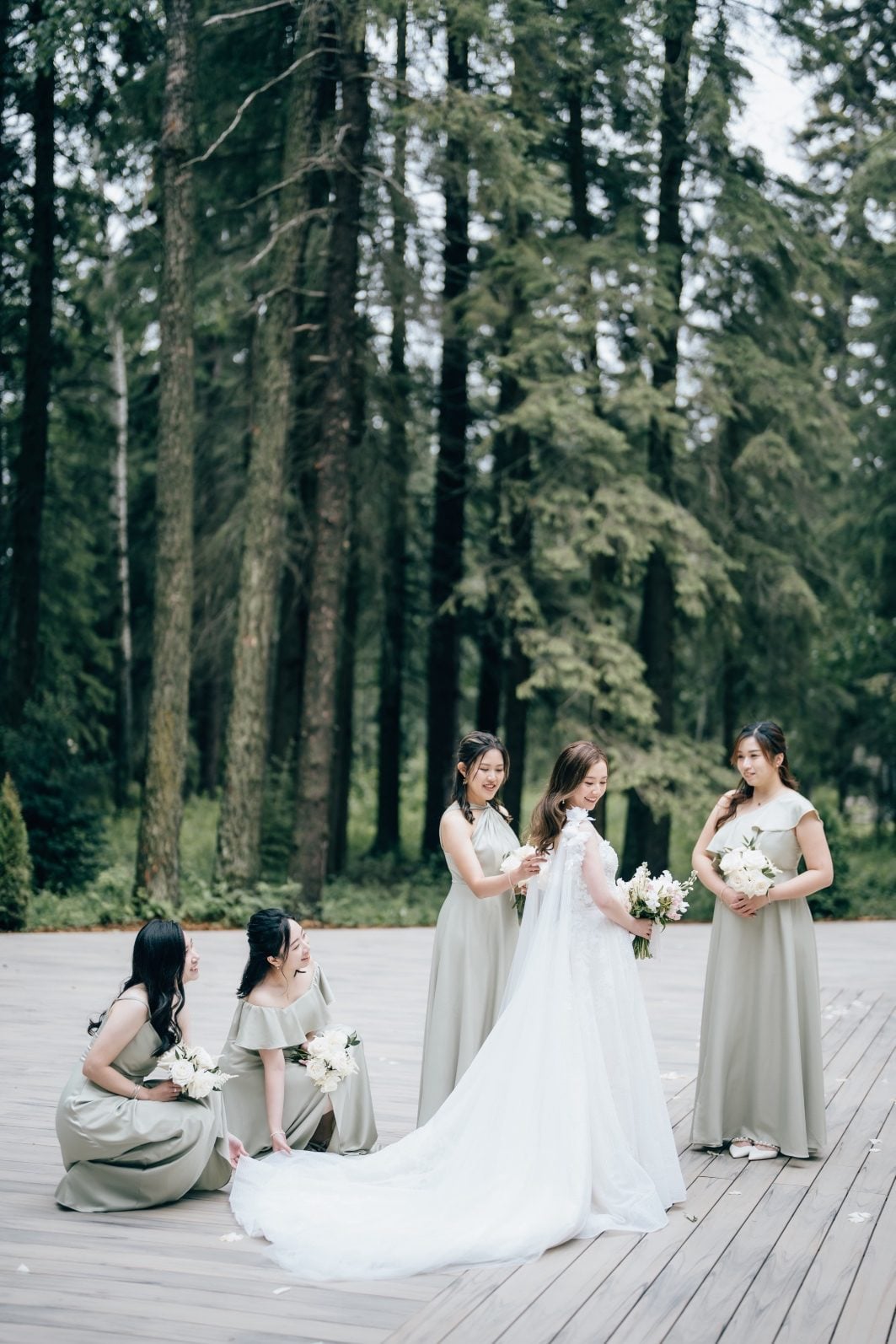 Bridesmaids help adjust the brides veil at this luxury Archway Manor Wedding.