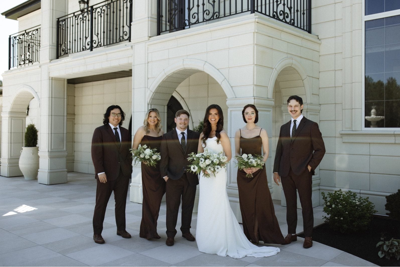 Chocolate Bridal Party at Archway Manor Calyx Bride stands outside Archway Manor with her bridal party, wearing chocolate brown.