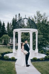 Bride and Groom pose in front of the beautiful gazebo at Archway Manor