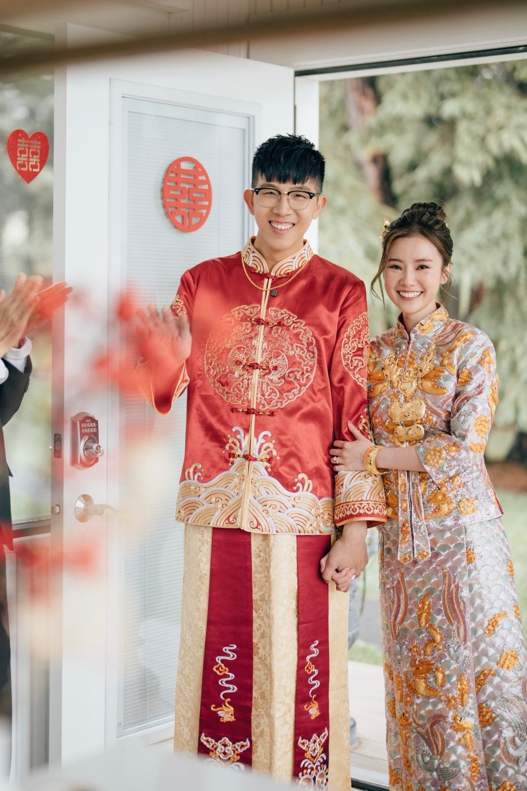 Bride and groom standing close together in Traditional Chinese attire for a Tea Ceremony.
