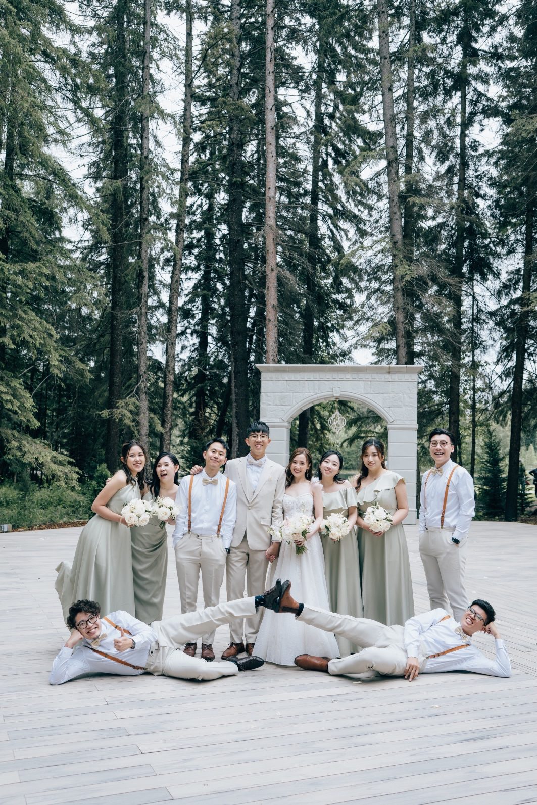 Bride and Groom posing with their entire wedding party at Archway Manor.
