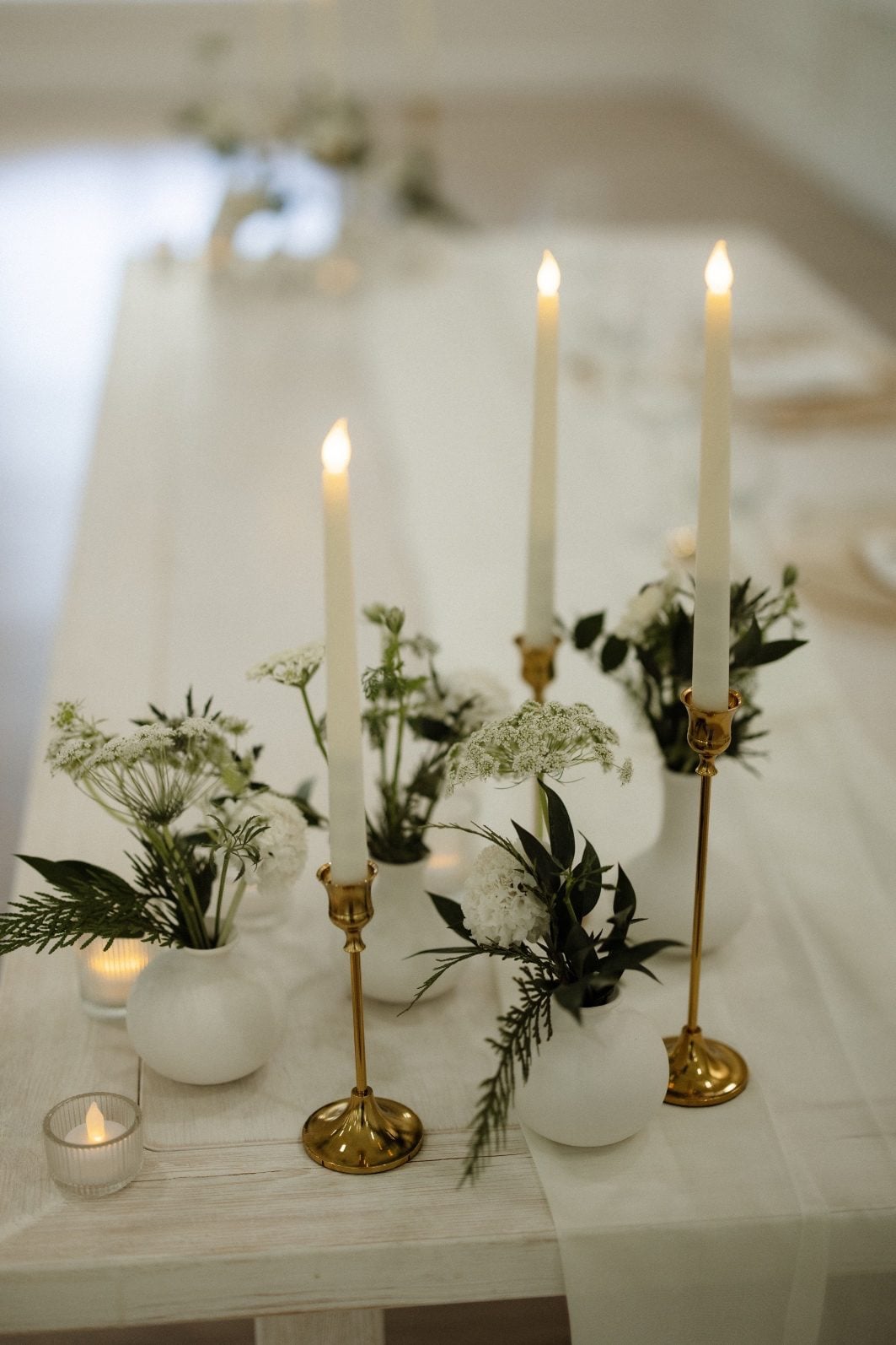 White + Green Sweetheart Table Accents White and green bud vases, and white taper candles accenting the sweetheart table at Archway Manor.