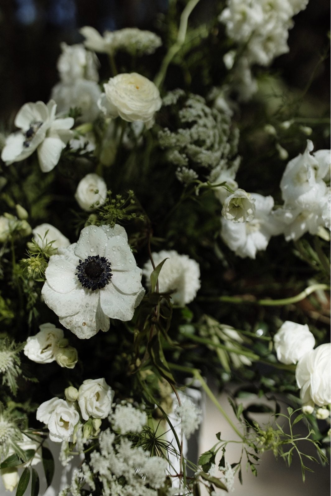 White and Green Ceremony Flowers Close Up Close up of white and green pillar arrangements at Archway Manor ceremony including anemone, orlaya, scabiosa, ranunculus and lisianthus.