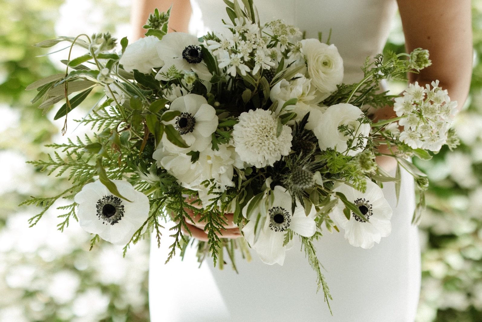 White and Green Garden Inspired Bridal Bouquet Stunning white and green bridal bouquet with garden inspired blooms like anemones, orlaya, ranunculus and lisianthus.
