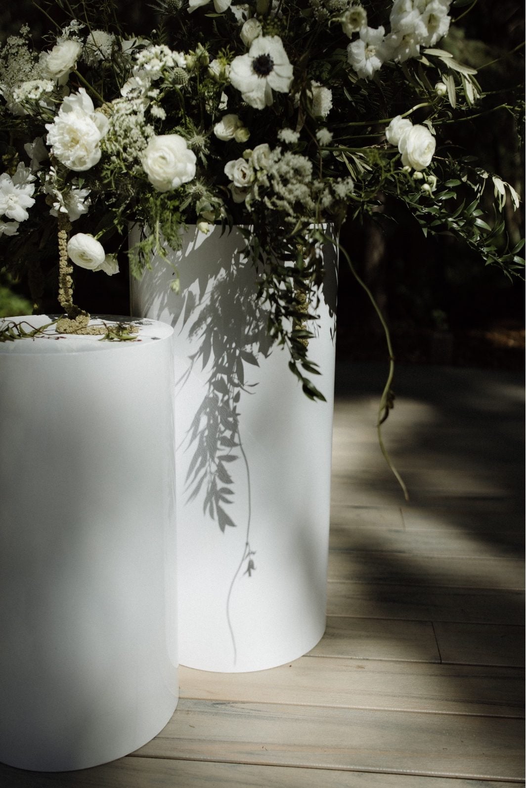White and Green Pillar Arrangemets White and green garden inspired arrangements on top of white pillars at the Archway Manor ceremony.