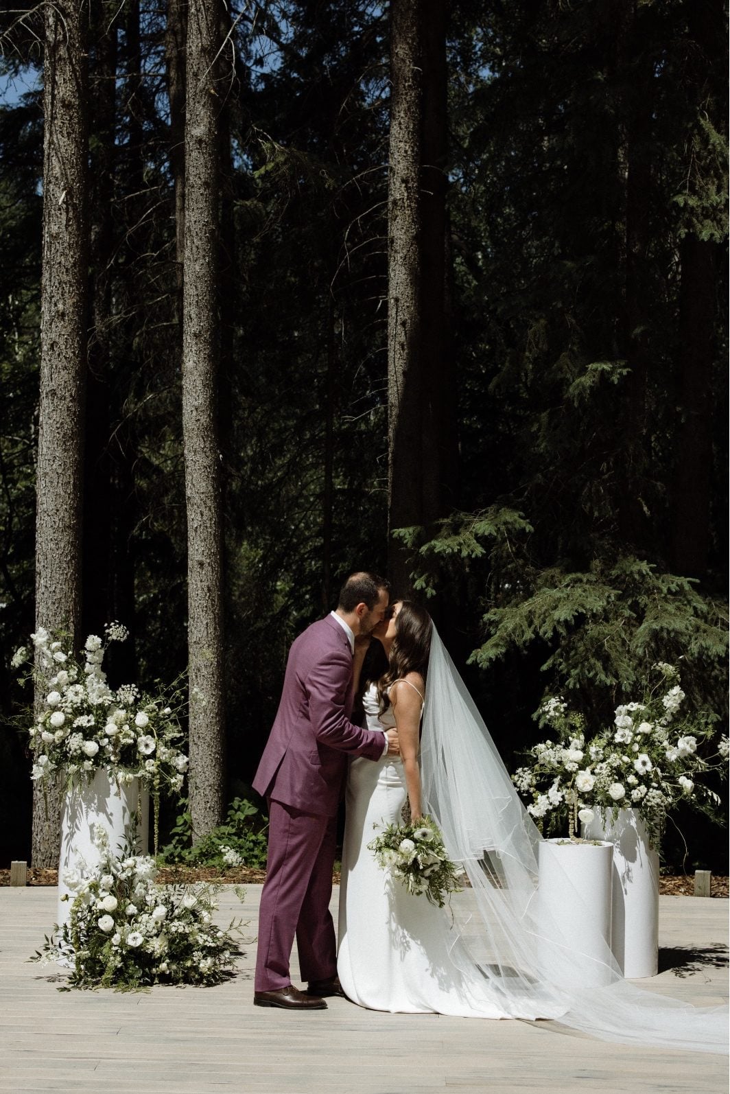 White and GreenWedding Ceremony Bride and Groom kiss during their white and green wedding ceremony at Archway Manor.