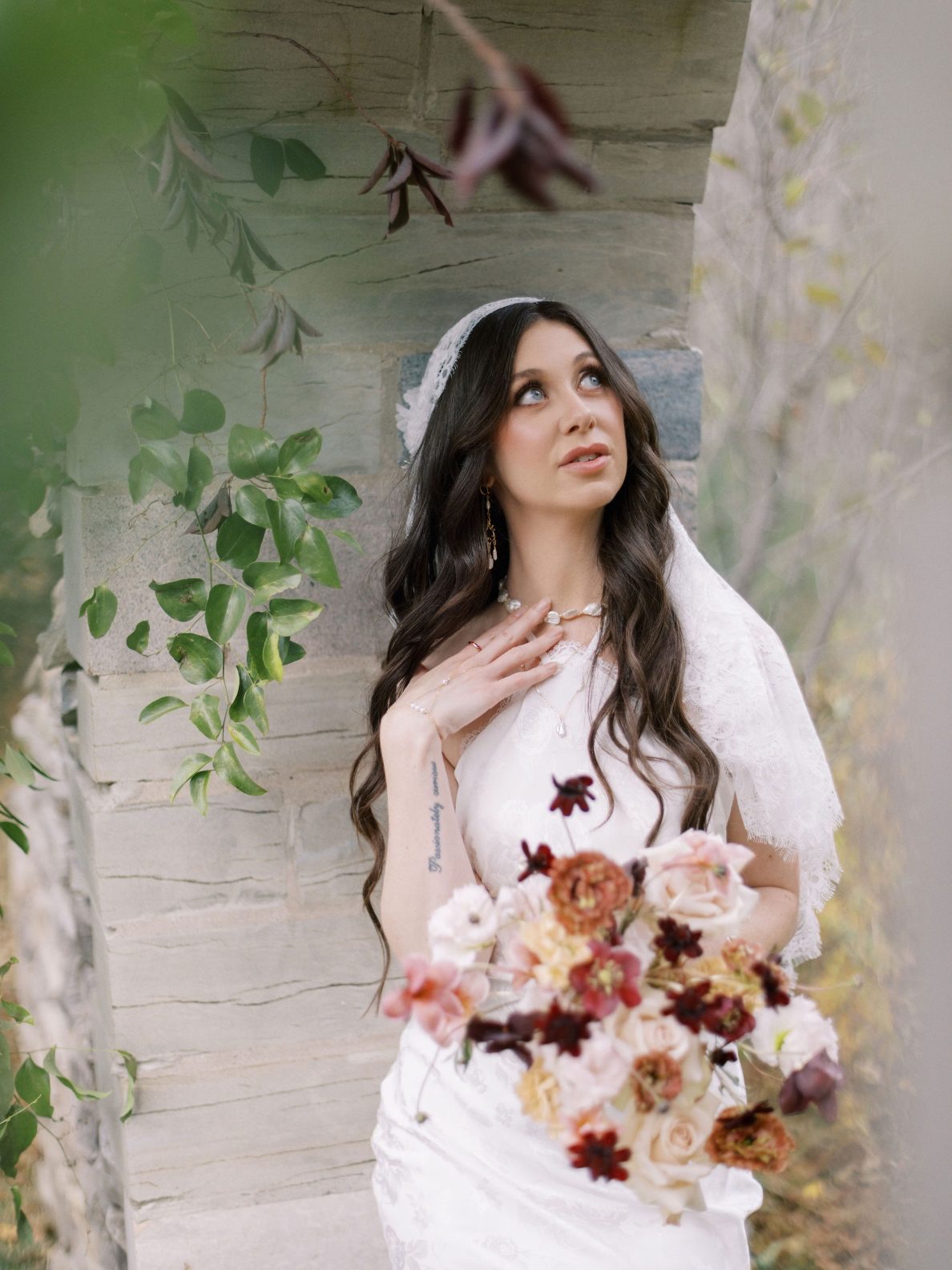 Justine Milton Marsala Bride + Bouquet Model bride from marsala true to hue photoshoot, wearing a Juliet veil and holding a blush to burgundy bridal bouquet.