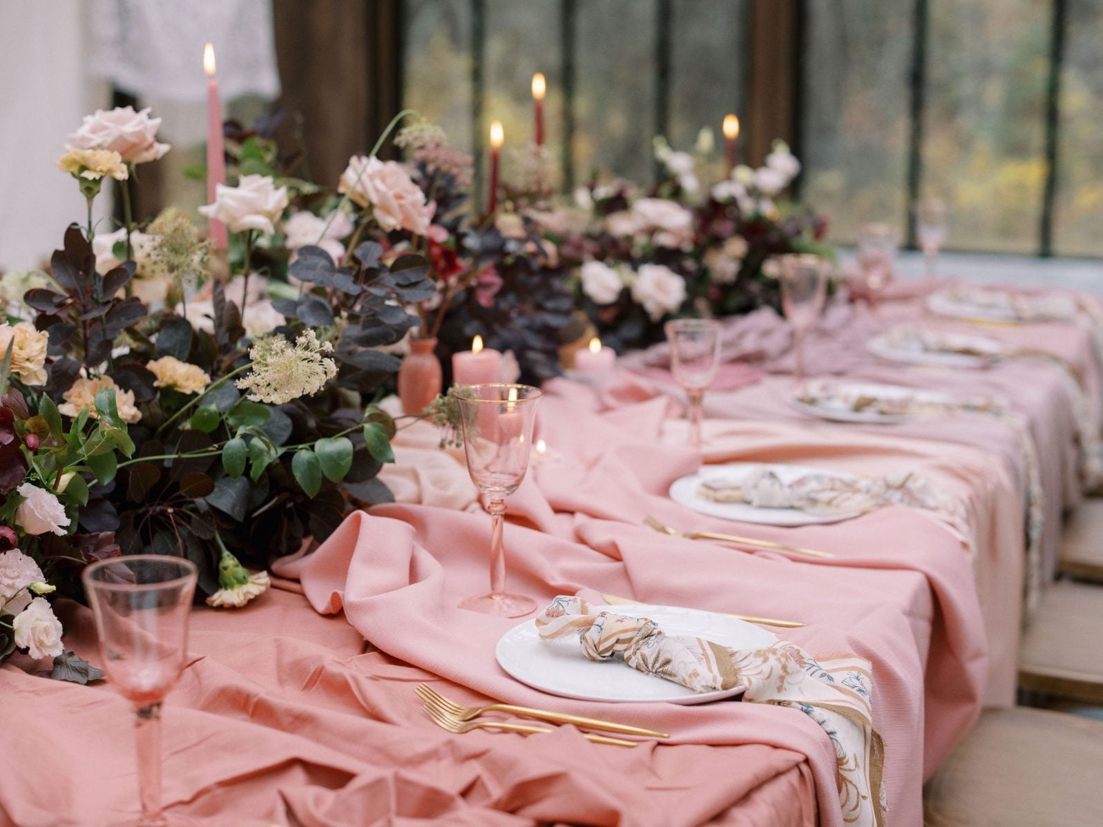 Justine Milton Marsala Floral Centrepieces Marsala True to Hue table scape with bohemian draped fabrics with lush centrepieces in blush, beige and burgundy accented by candles.