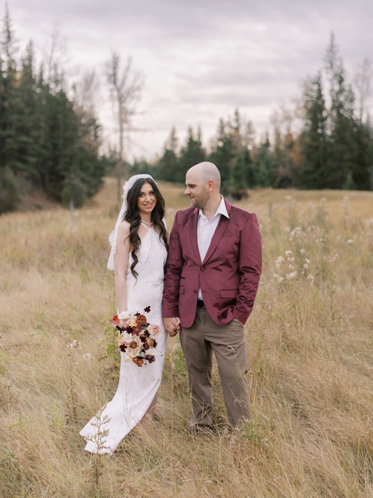 Justine Milton True To Hue Marsala Couple Model couple stand in an autumn grassy meadow at The Valley Weddings, for this True to Hue photoshoot by Bronte Bride.