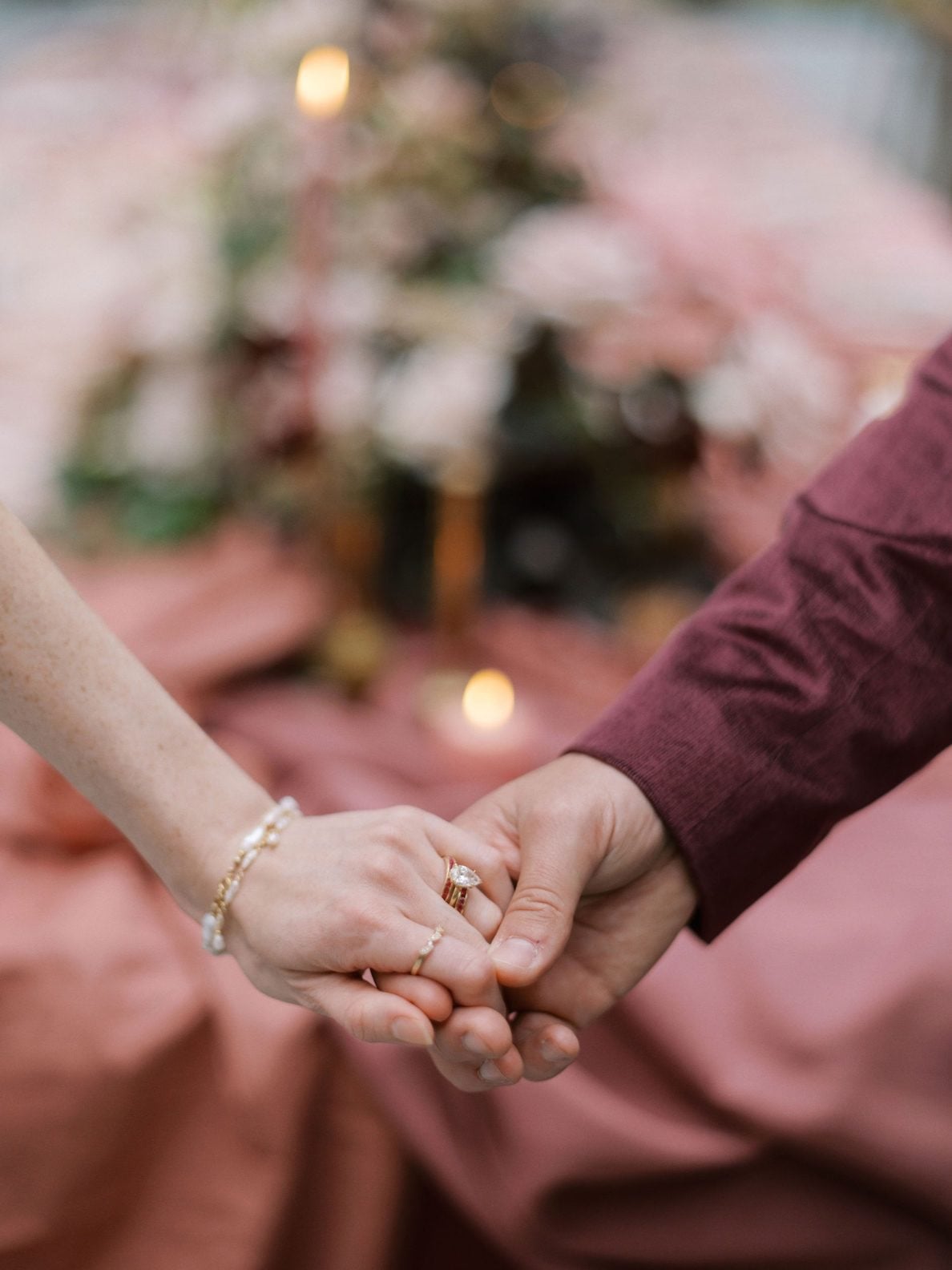 Justine Milton True to Hue Holding Hands Couple hold hands in front of the marsala inspired table scape, showing off her beautiful ring and jewelry for this True to Hue Shoot.