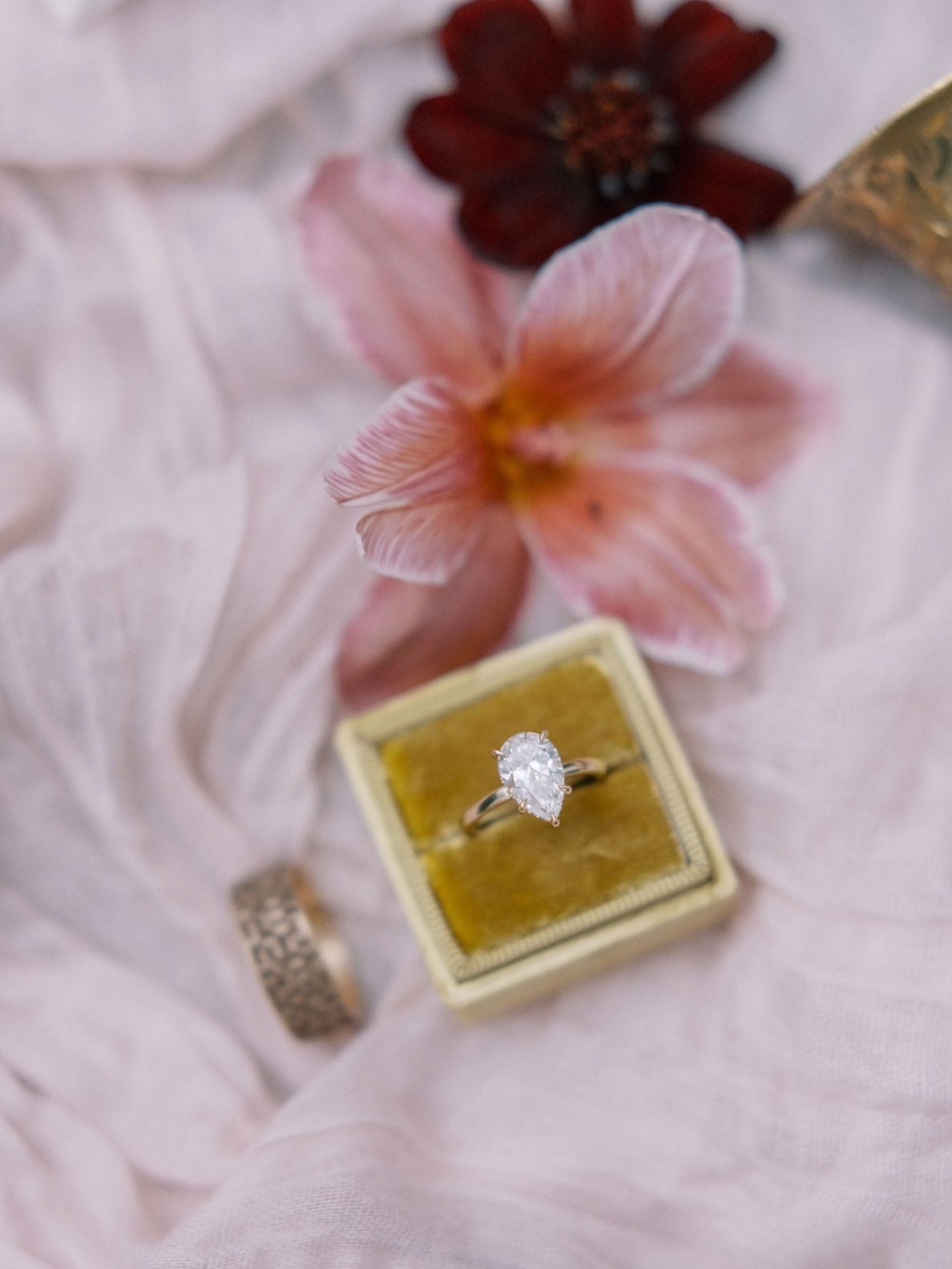 Justine Milton True to Hue Marsala Rings Stunning ring against pale pink gauzy fabric and a couple blooms in pink and burgundy for Bronte Bride's Marsala True to Hue Shoot.