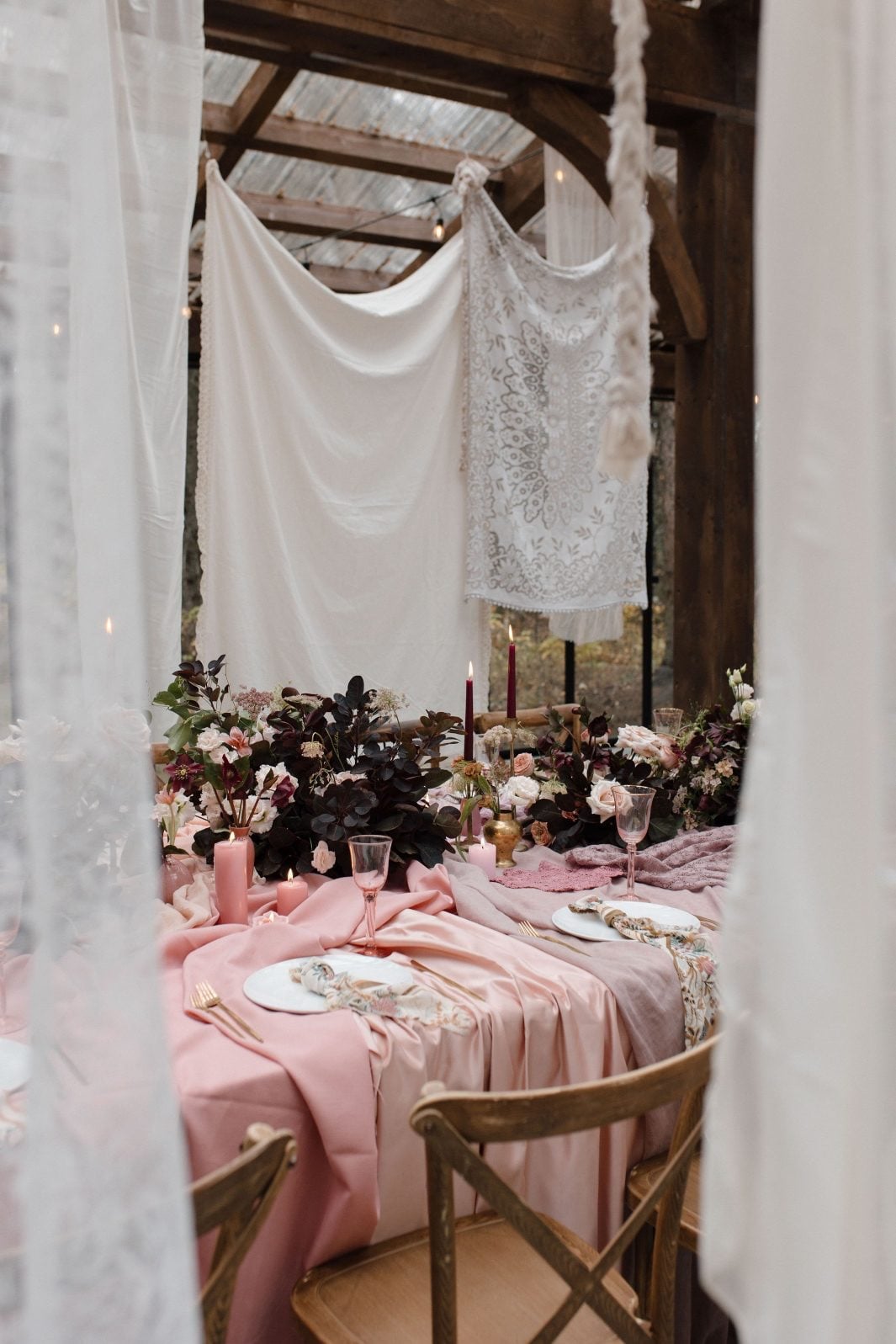 Nikki Collette Marsala True to Hue Tablescape Decor The marsala inspired table scape shot from between a couple of the suspended gauzy fabrics suspended from the ceiling for a bohemian look at this True to Hue photoshoot.