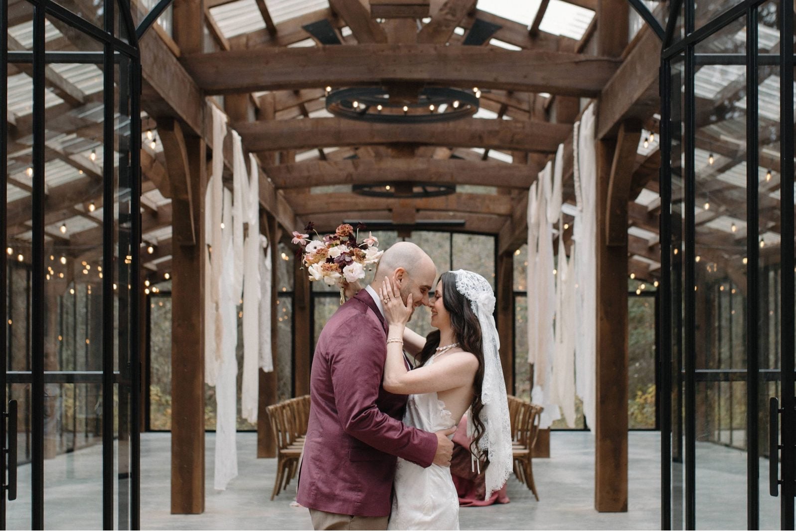 Nikki Collette True to Hue Couple at The Valley The couple embrace in front of the open doors of the reception space at The Valley.