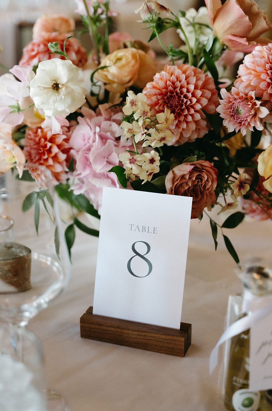 Close up of gorgeous pink and peach garden inspired centrepiece featuring "Peaches and cream" dahlias.