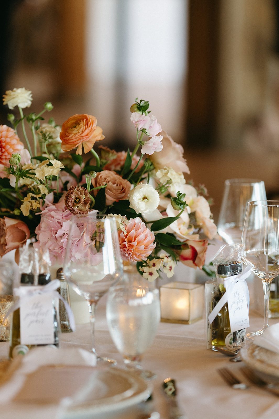 Pink and peach floral centrepiece of garden inspired blooms like hydrangea, dahlias, ranunculus, roses, lisanthus and phlox.