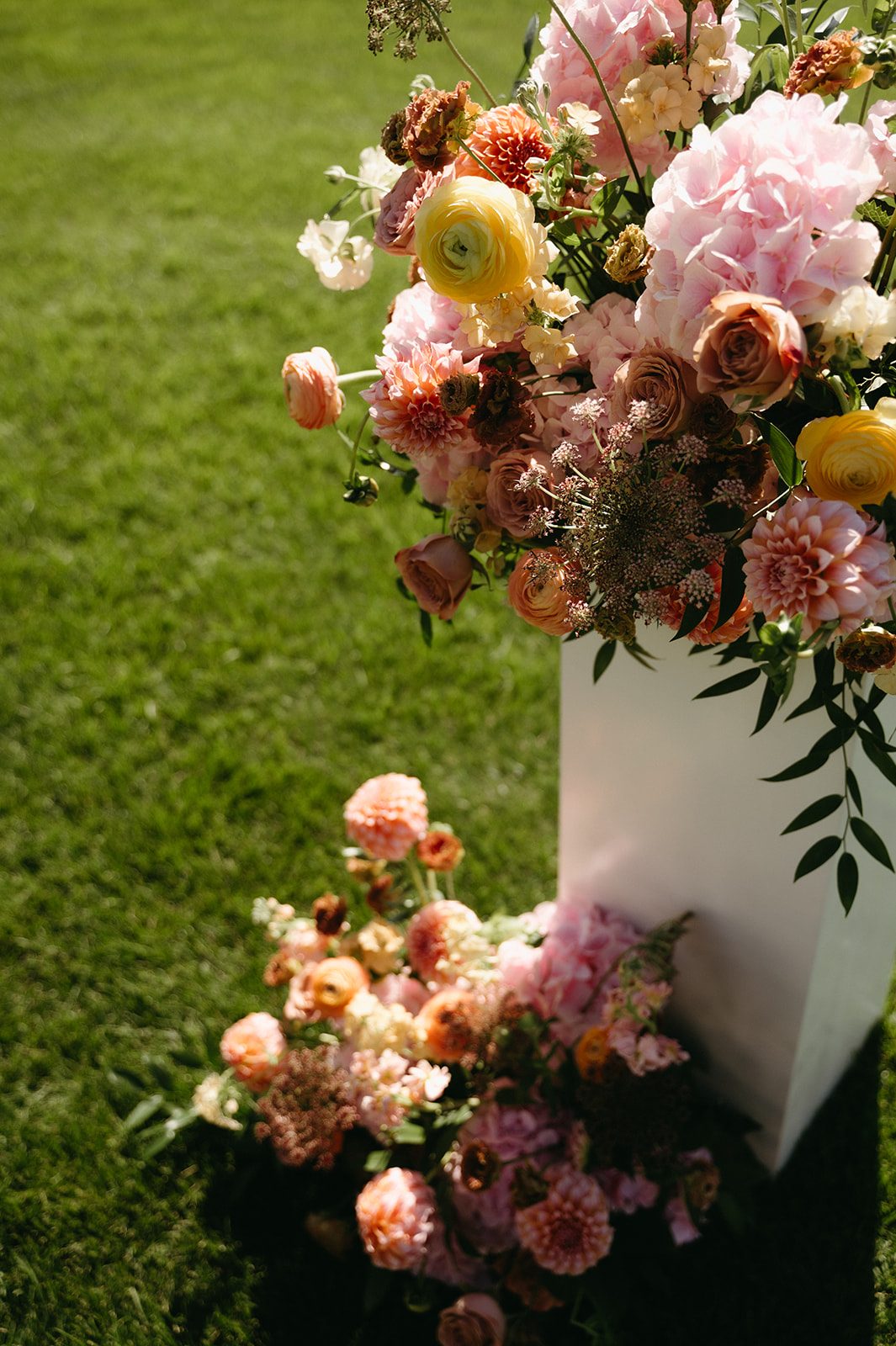 Garden inspired arrangements at this pink and peach ceremony at Pinebrook Golf & Country Club.