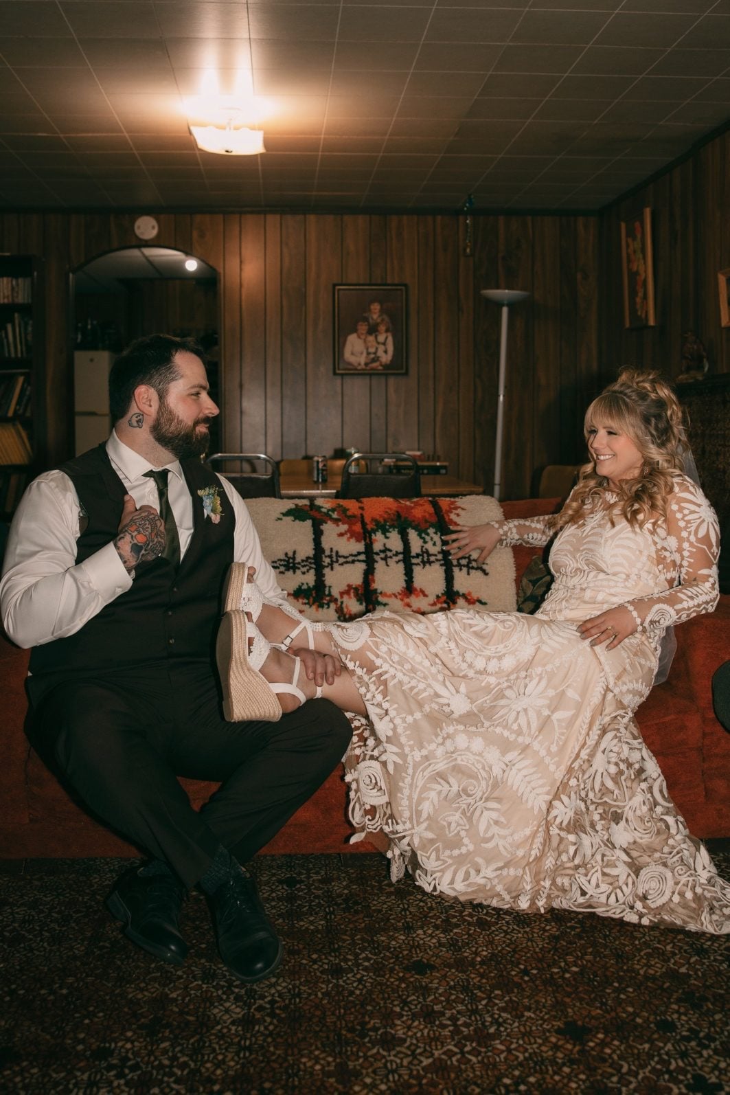 Bride and groom relaxing together in a vintage inspired room after their outdoor wedding celebration.