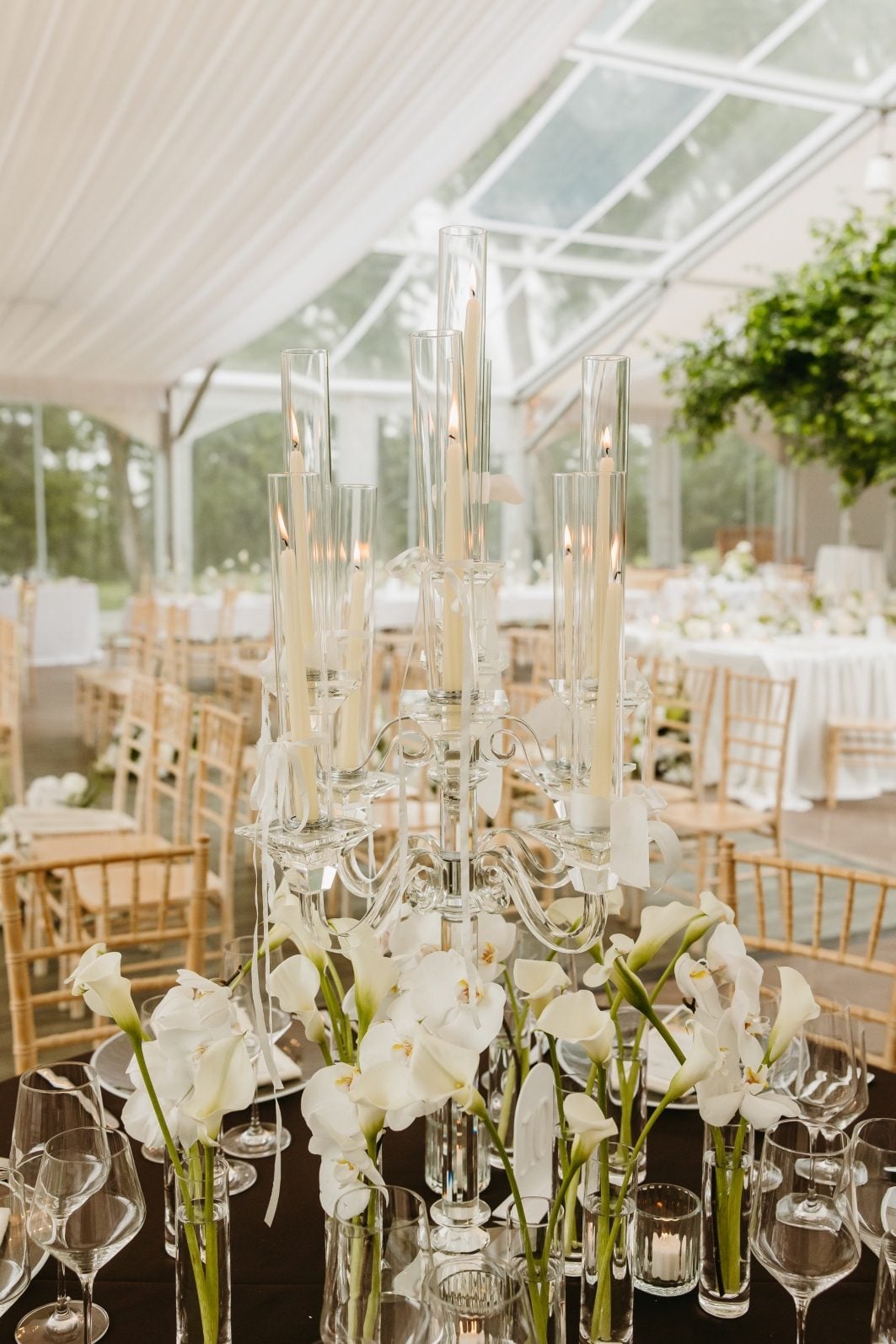 White + Green Wedding Flowers Budvase Centrepiece Elaborate white and green floral centrepiece featuring stunning crystal candelabra surrounded by bud vases of callas and orchids.