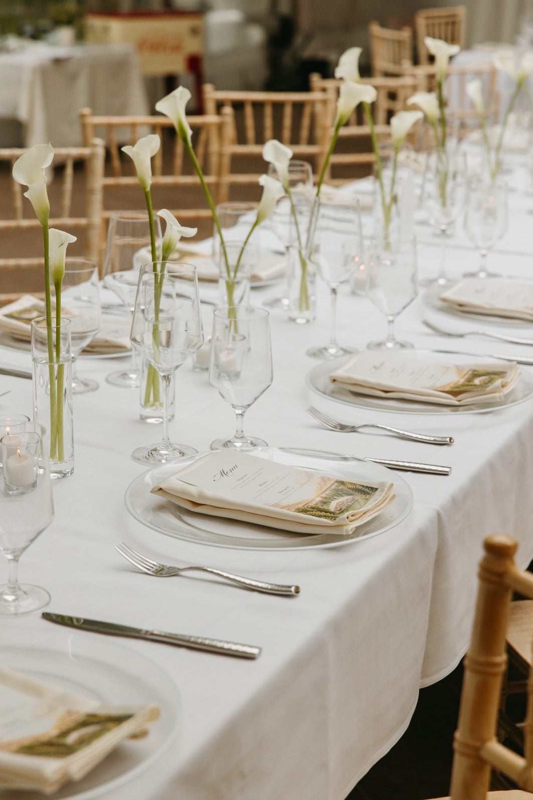 White + Green Wedding Flowers Calla Budvases Harvest table with bud vases of white calla lilies running down the length of the table.
