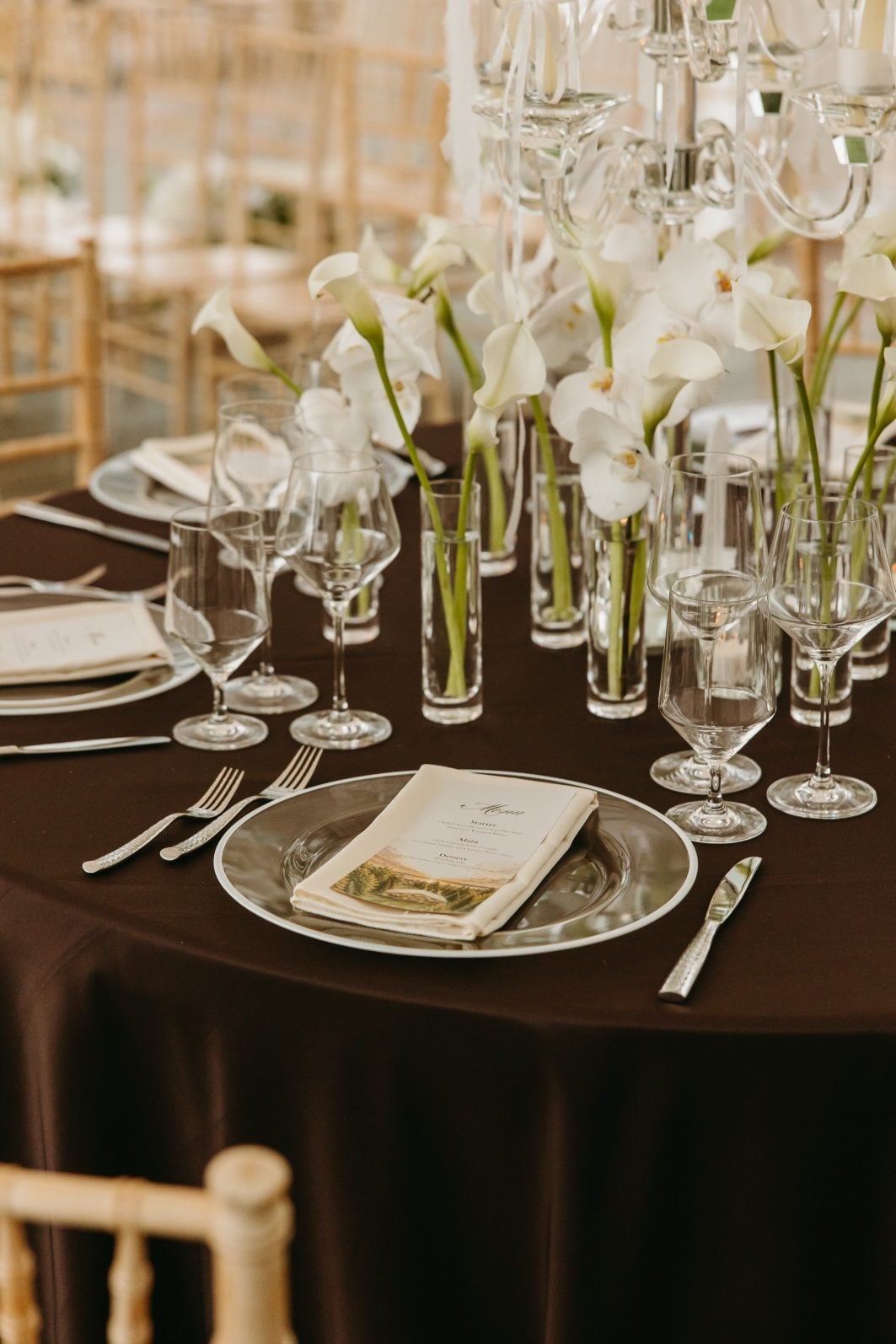 White + Green Wedding Flowers Centrepiece Budvase Clusters Close up of the clustered bud vases filled with callas and orchids for these white and green wedding flower centrepieces.