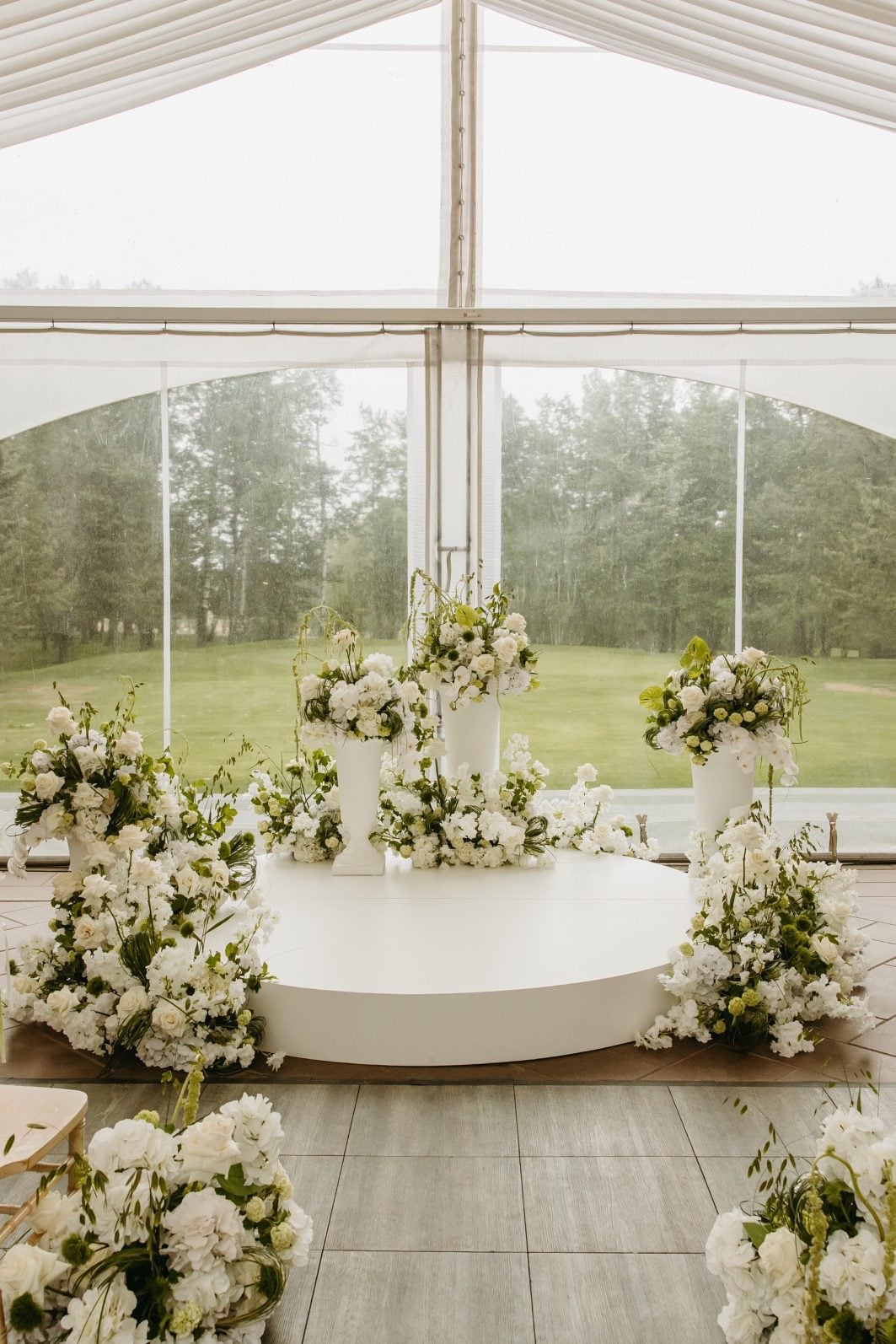 White + Green Wedding Flowers Ceremony Altar Stunning white and green wedding floral altar, with abundant structural arrangements arranged in an organic, asymmetrical design around the circular altar.