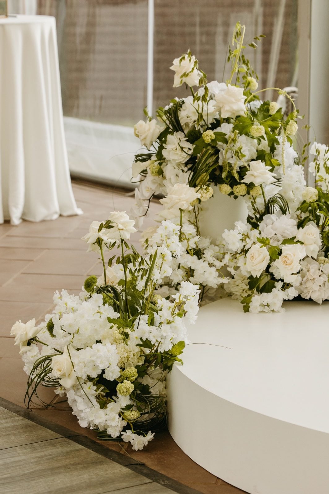White + Green Wedding Flowers Ceremony Arrangements Close up of the white and green flower ceremony arrangements adorning the circular altar.