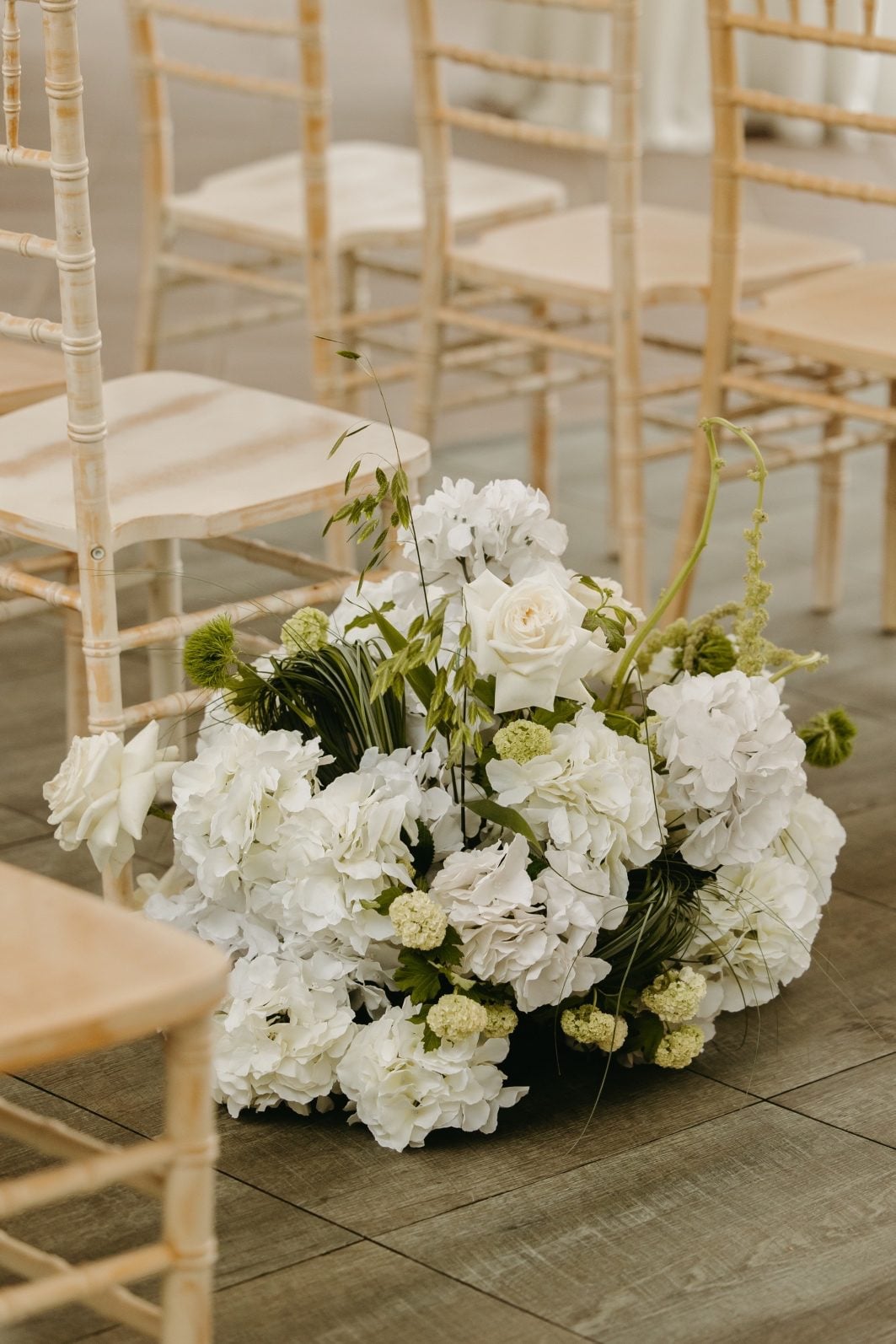 White and Green Wedding Flowers Aisle Arrangement Gorgeous, sculptural aisle arrangement in white and green wedding flowers including hydrangea, roses, viburnum, amaranths and structural grasses.