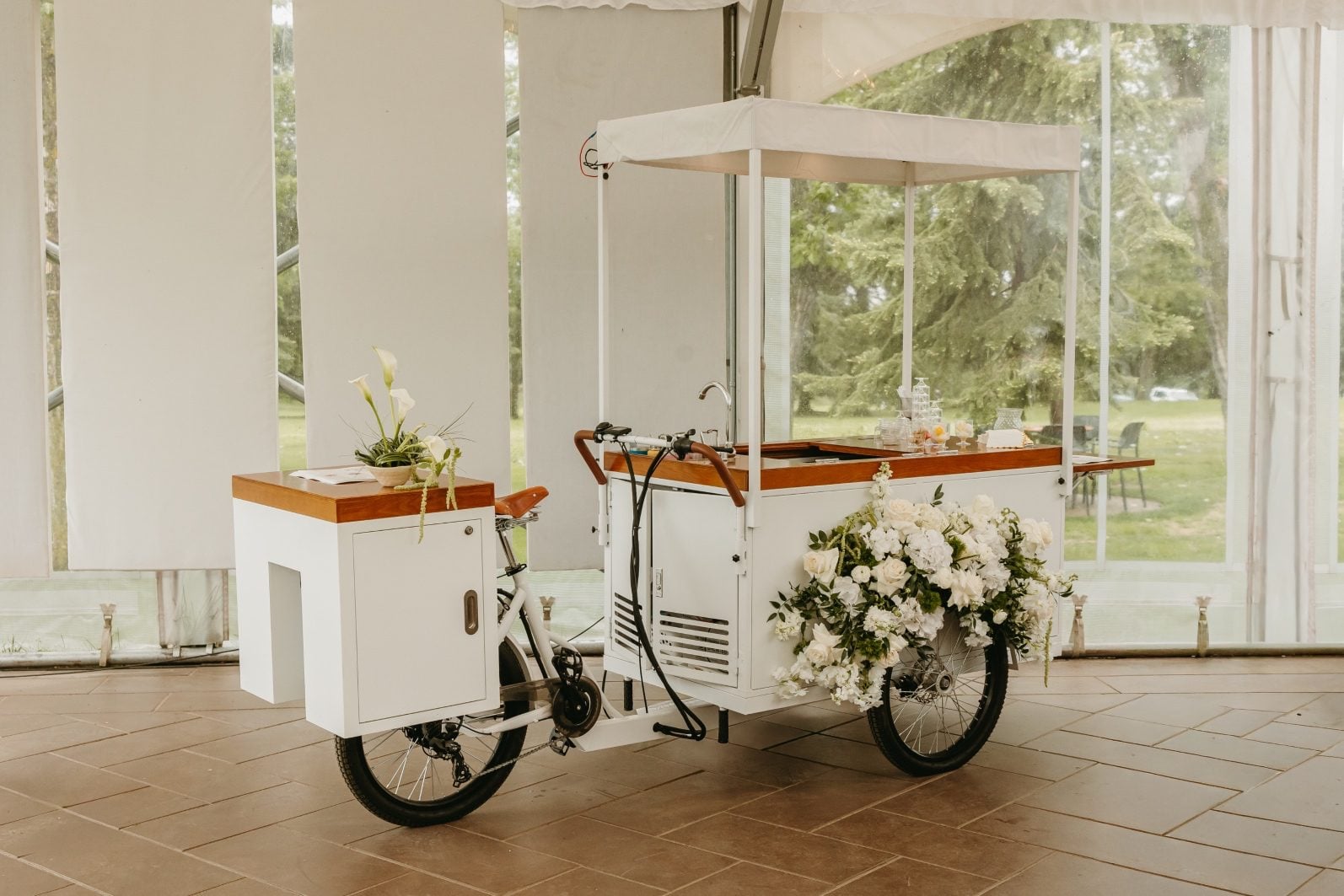 White and Green Wedding Flowers Ice Cream Cart Hilltops "The Sweet Pedal" mobile ice cream cart adorned with white and green flowers.