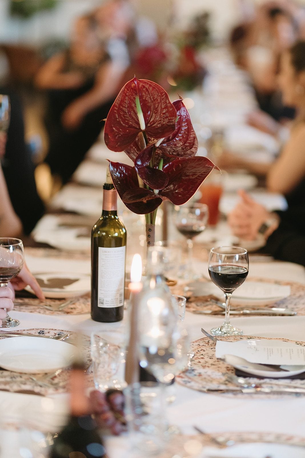 Andi + Logan Sculptural burgundy anthurium bouquet with a minimalist design at an intimate fall reception.