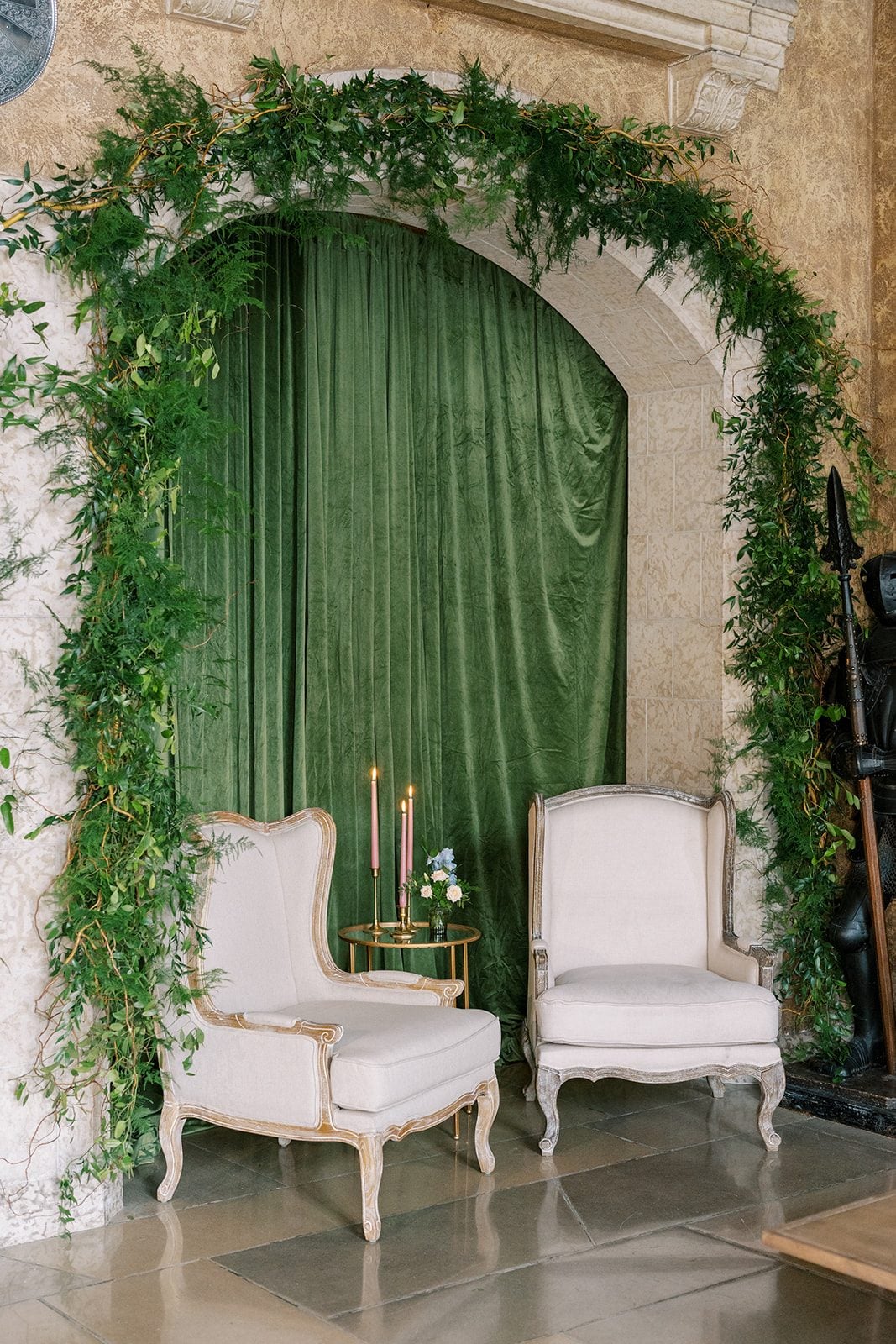 Lottie Lush greenery framing the stone arches of Mount Stephen Hall at the Fairmont Banff Springs.