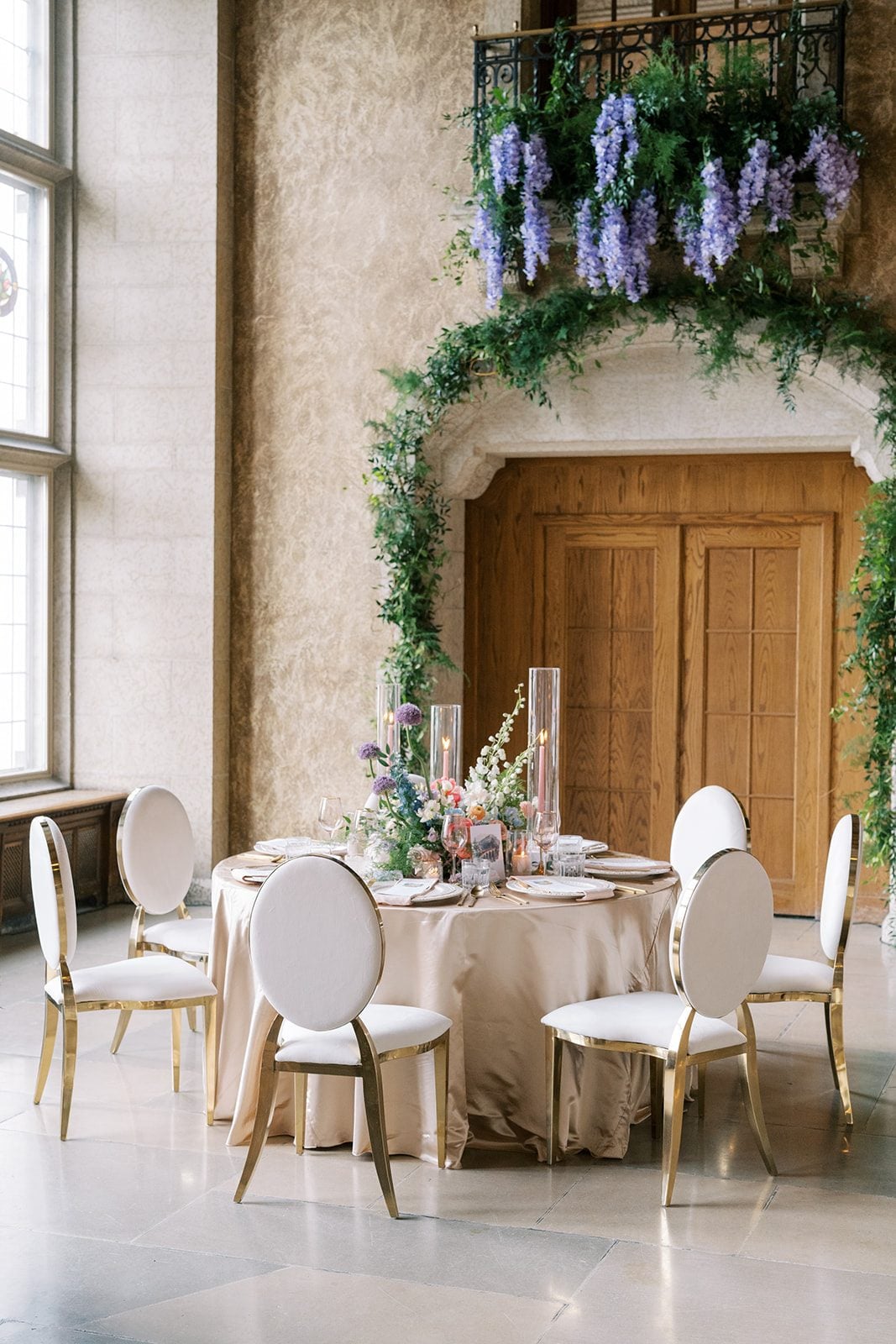 Lottie Colourful garden inspired wedding centrepiece with allium, delphinium, roses, ranunculus and airy greenery at the Fairmont Banff Springs.