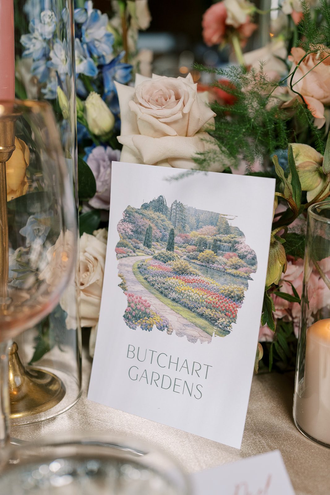 Lottie Butchart Gardens table card nestled among colourful garden inspired wedding flowers.