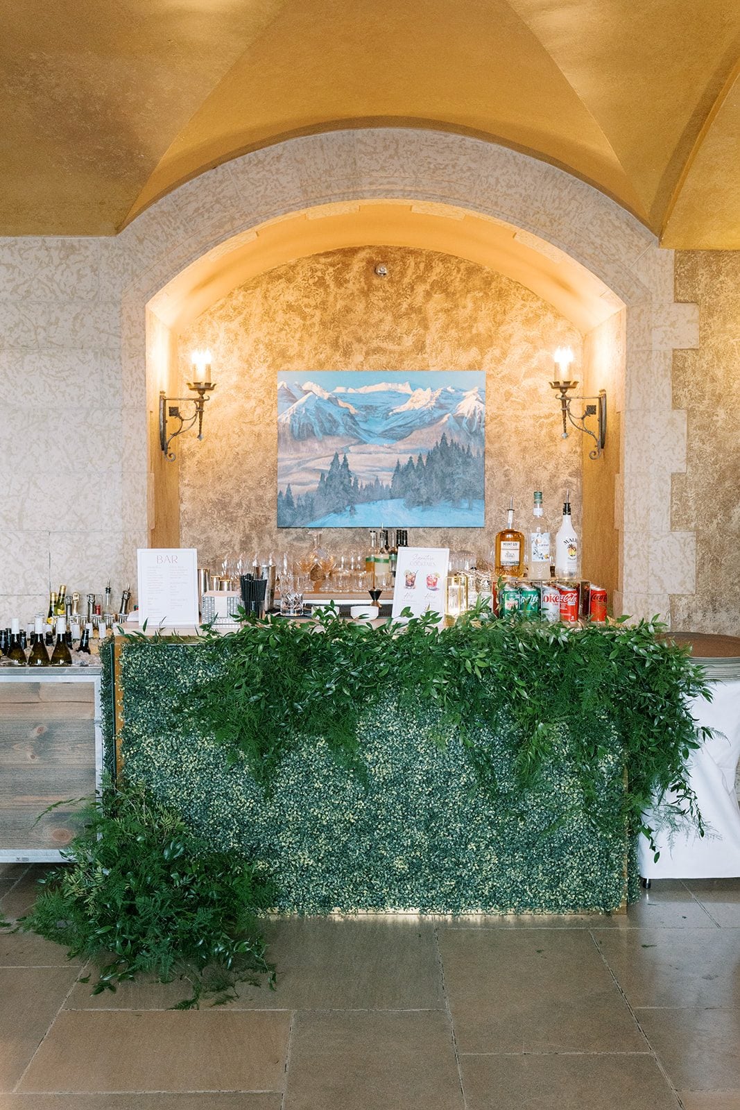 Lottie Fairmont Banff Springs wedding bar decorated with a lush installation of cascading greenery.