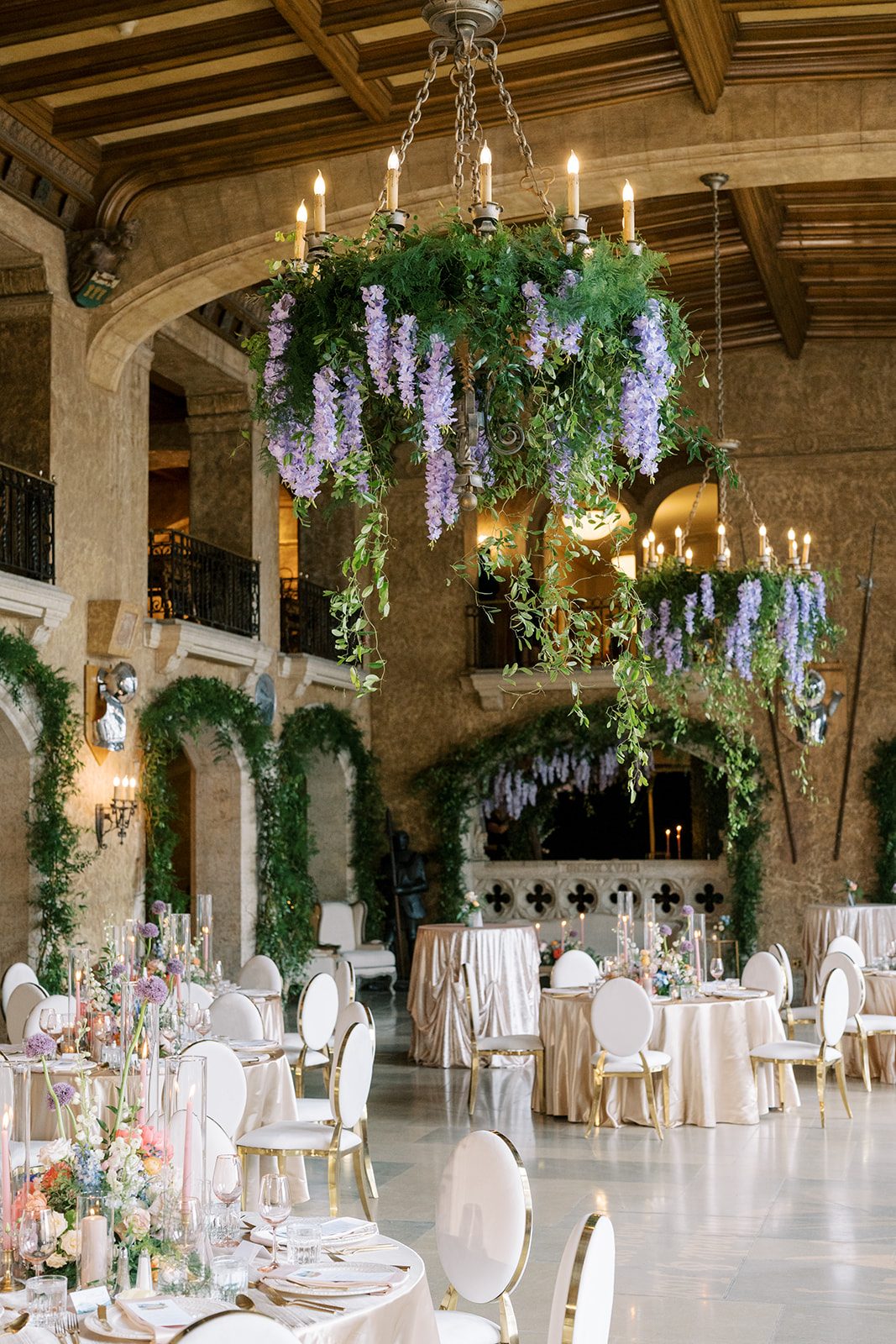 Lottie Fairmont Banff Springs wedding reception in Mount Stephen Hall with colourful floral centrepieces and greenery covered chandeliers.