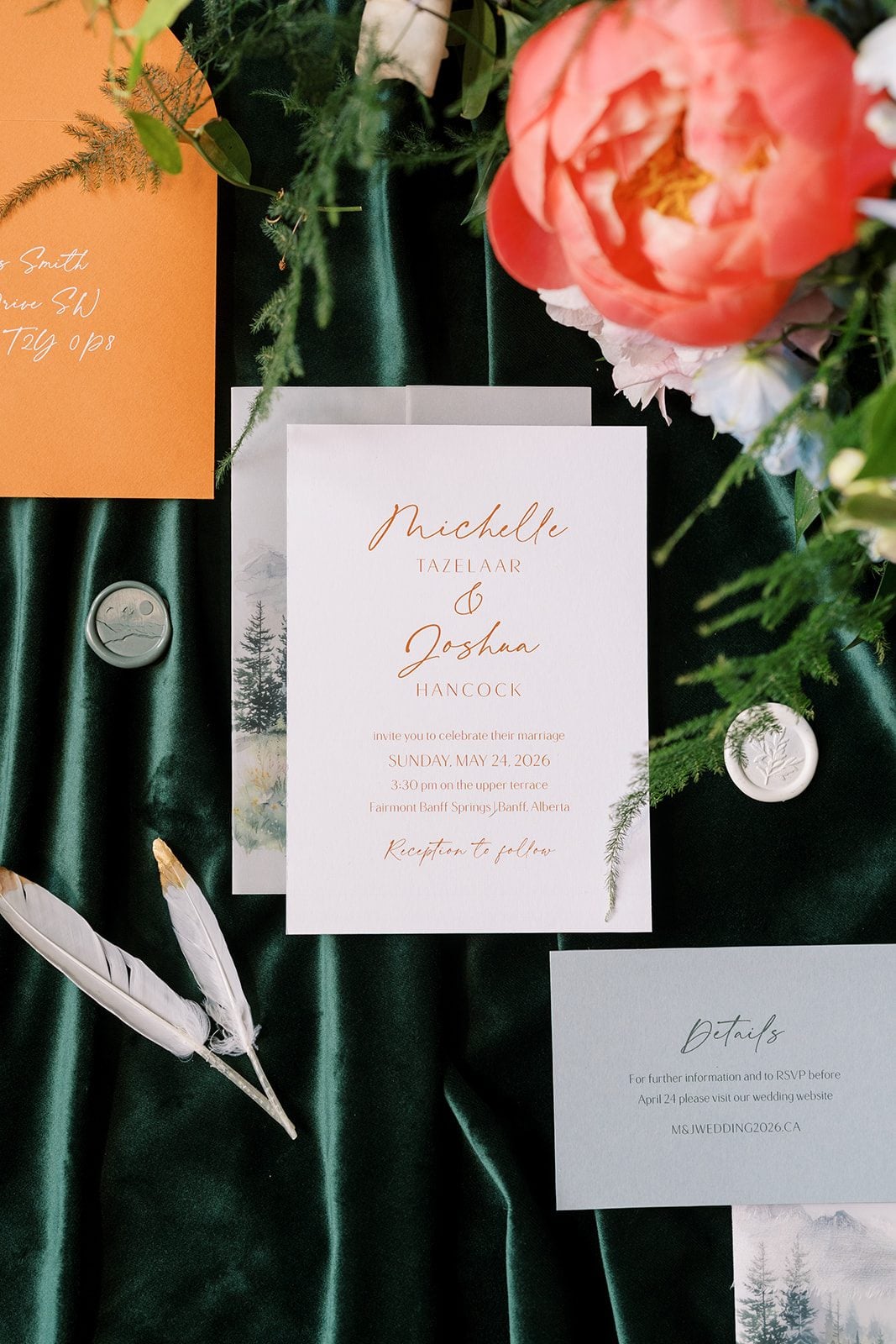 Lottie Fairmont Banff Springs wedding invitation styled with coral peonies, greenery and emerald green velvet.