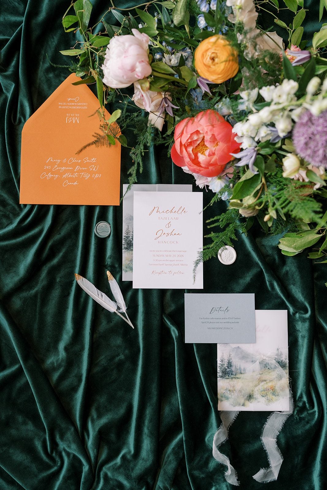 Lottie Wedding stationery surrounded by colourful garden flowers and greenery for a Fairmont Banff Springs wedding.