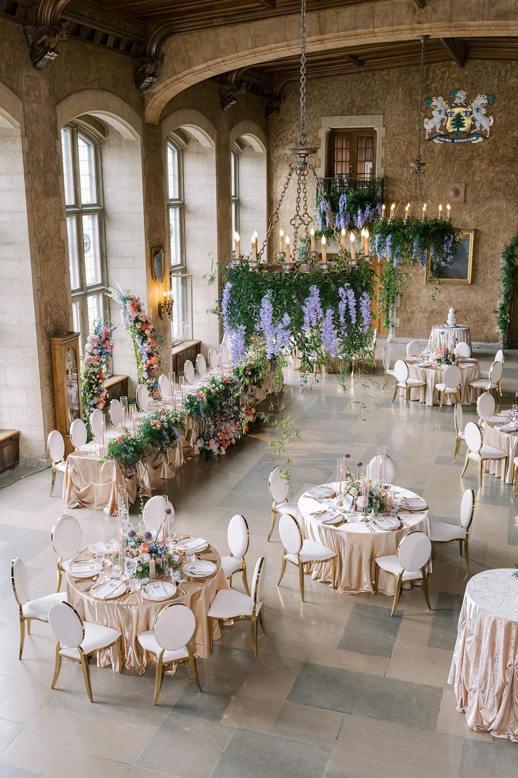 Lottie Mount Stephen Hall wedding reception at the Fairmont Banff Springs with lush greenery, hanging florals and colourful garden inspired flowers.