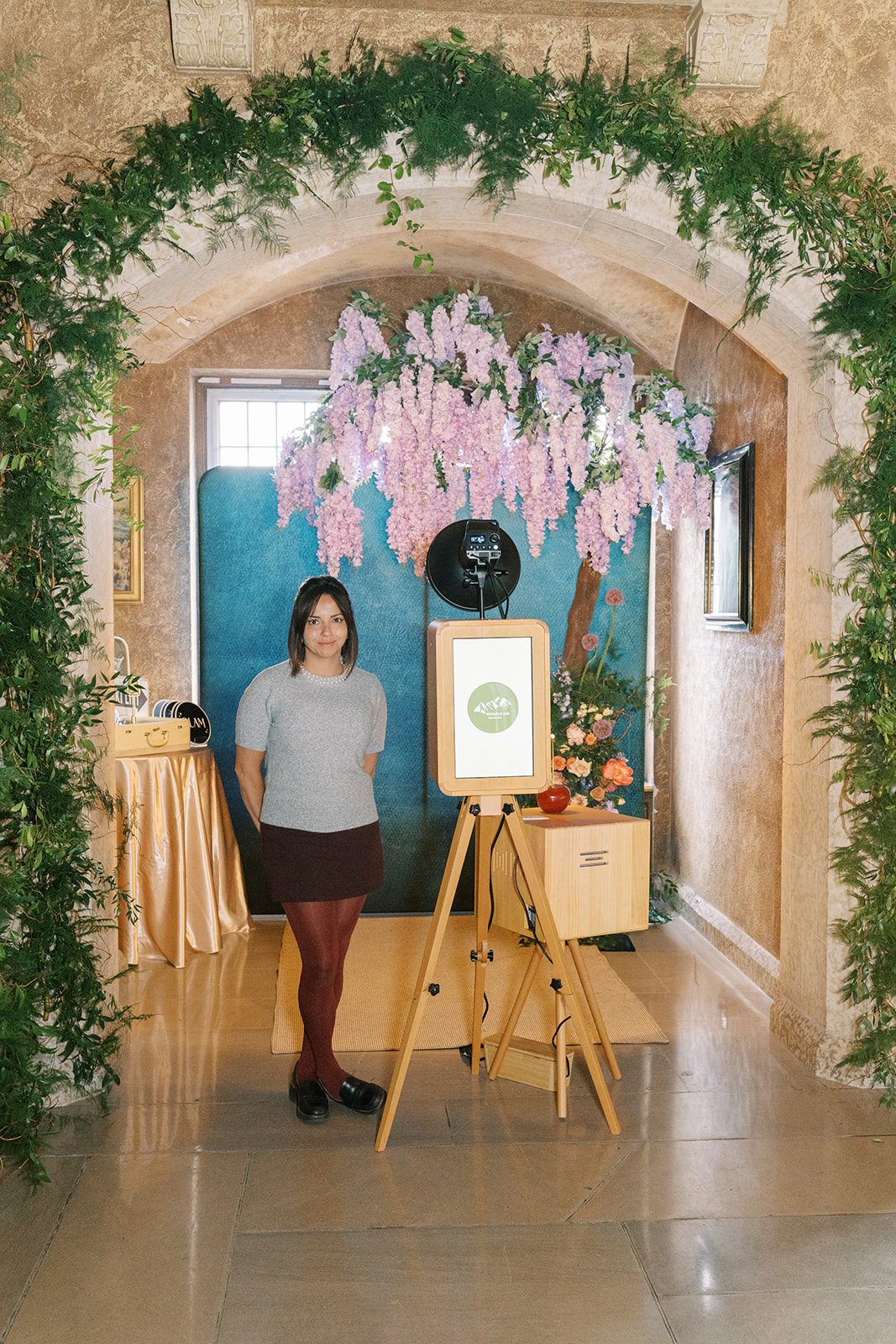 Lottie Wedding Photo Booth framed by lush greenery and cascading lavender flowers at the Fairmont Banff Springs.