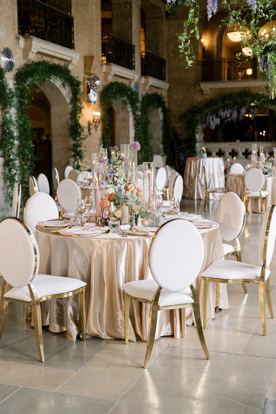 Lottie Elegant wedding reception with champagne linens, colourful garden inspired centrepieces and abundant greenery at the Fairmont Banff Springs.