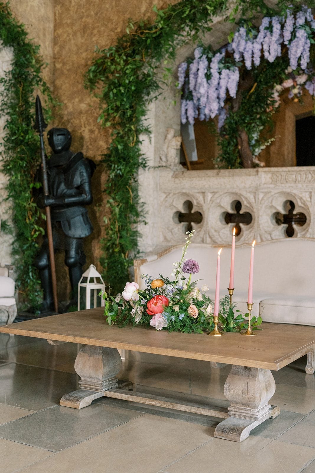 Lottie Colourful garden inspired floral arrangement with coral peonies and pink taper candles on a wooden table in Mt. Stephen Hall.
